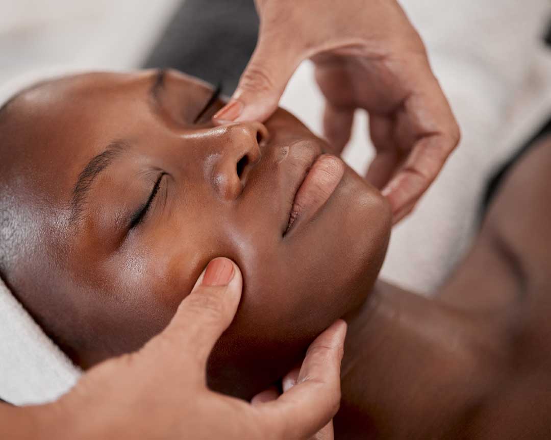 Black Woman, Relax Massage And Facial Spa Treatment Of A Young Female Face With Serum. Skincare, Beauty And Wellness Clinic With Client Feeling Calm And Zen From Dermatology Or Cosmetic Chemical Peel
